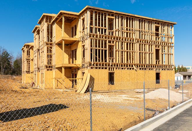 a temporary chain link fence in front of a building under construction, ensuring public safety in Anderson, CA